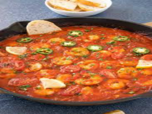 Shrimp Chili Recipes With Coconut Cornbread 12 a pan of food with a spoon