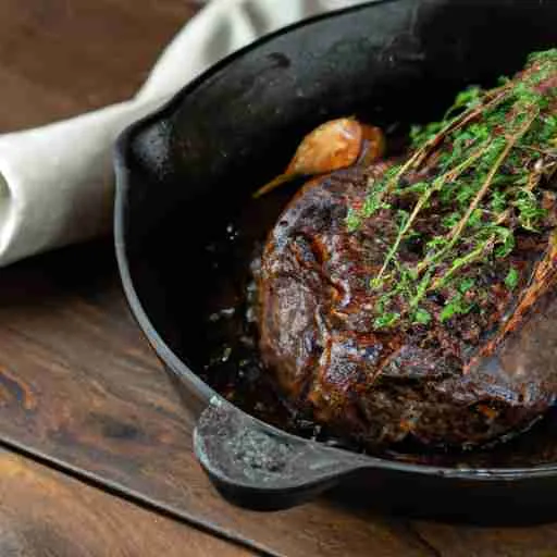 Cast Iron Skillet With Steak And Herbs